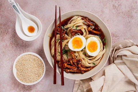 Buckwheat noodles soba with shimeji mushrooms, with boiled egg, green onion, sesame seeds,