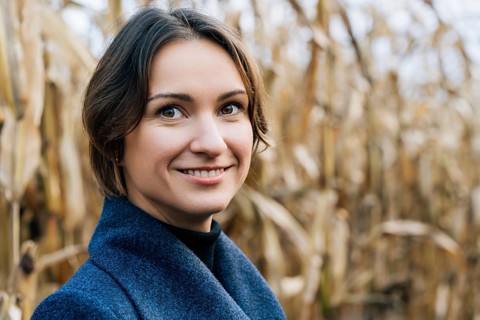 Happy smiling woman in autumn in cornfield