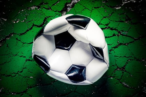 Platter soccer on ground with cracks, symbolic photo Balogun scandal of the 2026 soccer World Cup,