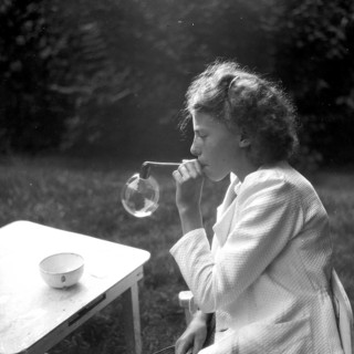 Girls blowing soap bubbles, all by themselves, sunk in, playing, concentration, happiness,