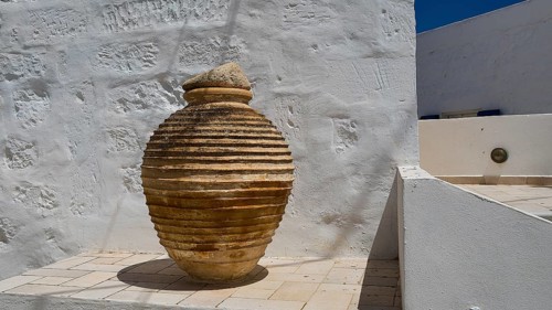 Large ceramic vessel on a roof terrace with white walls and shadows, main town on Kimolos, Kimolos,