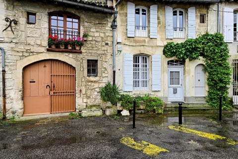 Green house facades in a district street in the city, Arles, Camargue, southern France, France