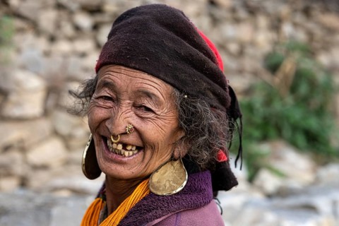 Portrait, friendly smiling elderly woman with traditional jewelry, Hindu ethnic group, Himalayas,