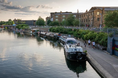 Houseboats moored, office and commercial buildings, Regent's Canal Towpath, Camden Town, London,