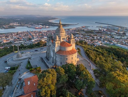 Drone shot of the Basilica of Santa Luzia at the golden hour with the city of Viana do Castelo and