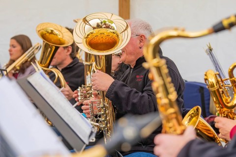 Musicians play brass instruments in a group with a focus on teamwork and harmony, Father's Day,