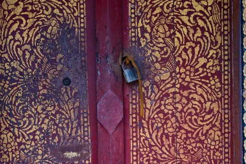 Artfully painted door with old castle, Buddhist temple, monastery, Wat May Souvannapoumaram, Luang