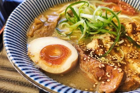Vegetarian tofu ramen with miso broth, soft boiled egg, bamboo shoots, soybean sprouts, onions and