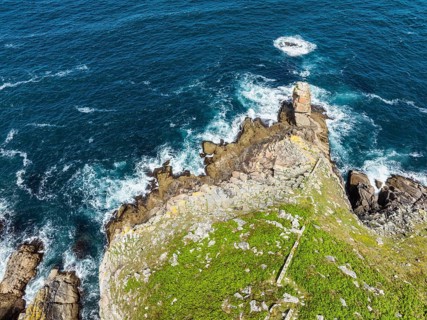 Aerial view, top down view of steep granite rocks at Pointe du Raz on the stormy Breton coast, at
