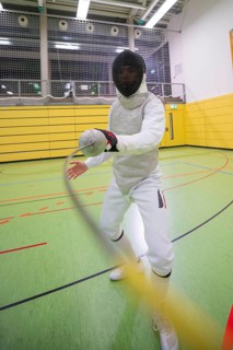 Fencers in action wearing a protective suit in a yellow-green sports hall, fencing, TSV Calw, Calw