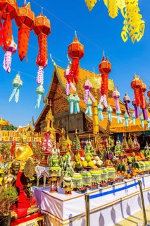 Sacrificial table with offerings and colorful lanterns lined up in the Wat Phra That Doi Suthep