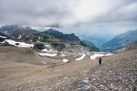 Mountaineers on hiking trail in bare rocky mountain landscape in bad weather, Rote Härd, Bernese