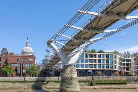 View under Millennium Bridge footbridge to dome of St Pauls cathedral, north bank of River Thames,