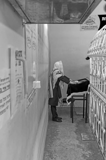 Orthodox Jew praying at the grave of Hasidic Rabbi Elimelech in the Jewish cemetery of Lezajsk,
