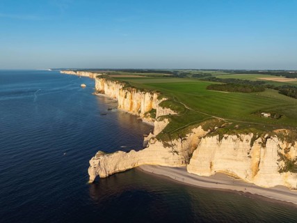 Aerial view of Porte d'Amont rock formation and landmark, Falaise d'Amont in the evening sun,