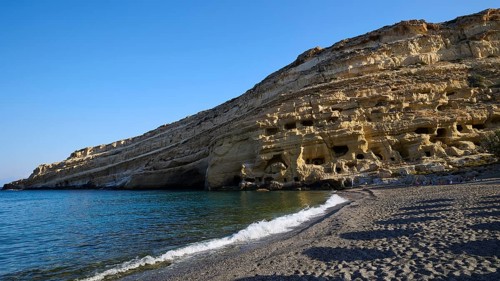 Neolithic caves, former hippie paradise, coast with distinctive rock formations and calm blue sea,
