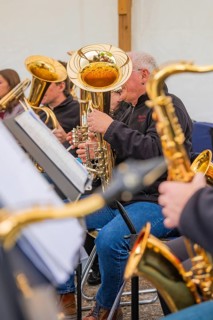 Musicians playing brass instruments in a close-up, focus on musical notes and instruments, Father's
