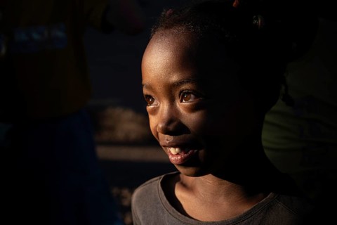 Portrait of a girl at the weekly market market in Ambalavao with light accents on her face