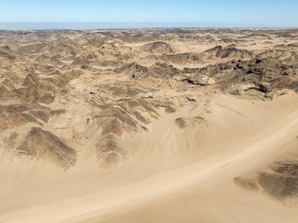 Aerial view, dry barren mountains in Moon Valley, rocky landscape ridged by erosion, Namib-Naukluft