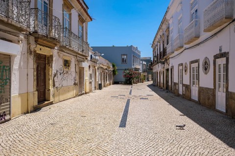 Narrow, paved street in a quiet old town when the sun shines, Olhão, Faro, Portugal