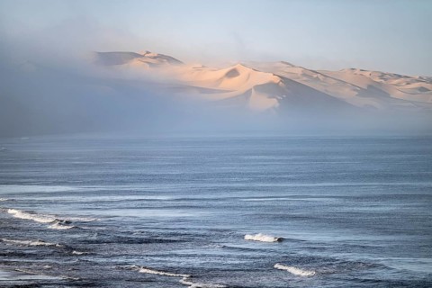 Atlantic coast, sea and sea fog in the morning, dunes of the Namib Desert, impressive desert