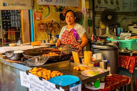 Chef preparing lard pastries in an open kitchen, Kad Luang Warorod Market, Chiang Mai Thailand