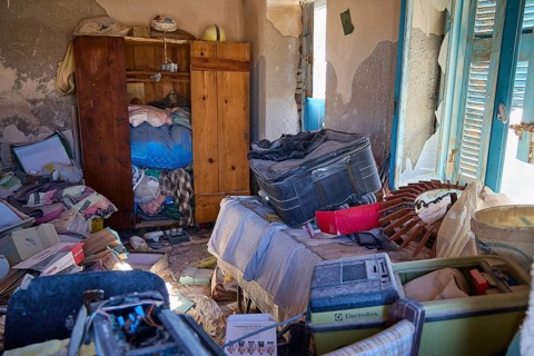 A neglected room with broken walls and a variety of old, jumbled objects, saltworks, lost place,