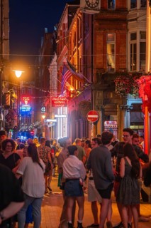 Lively night atmosphere with a large crowd on an illuminated street, nightlife, Dublin, Ireland