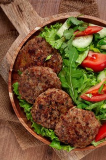 Fried cutlets, mixed minced meat, with vegetable salad, homemade, top view, no people