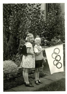 Berlin, Olympics 1936, Olympic flag, two children posing in a garden with a flag showing Olympic