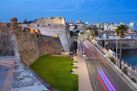 The Royal walls and bastions with a night view of the city of Ceuta, Spain, North Africa
