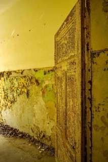 Old paint peeling off a door in thick flakes, former lung hospital and lost place Heilstätte