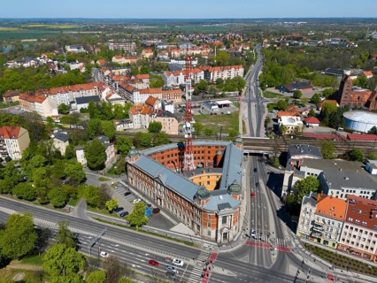 Aerial view of an urban center with distinctive buildings and a structured road network, aerial