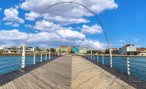 View from the wooden deck of the Queen Emma Bridge towards the iconic colorful colonial