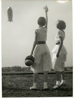 Zeppelin, over Berlin, girls, white clothes, Two woman waving at an airship while the wind moves
