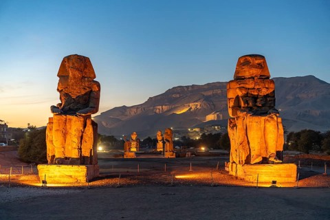 The Colossi of Memnon in the Nile Valley in West Thebes near Luxor at dusk, Egypt