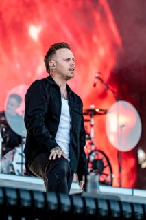 Singer Sam Carter from the British metalcore band Architects live on the Utopia Stage during the