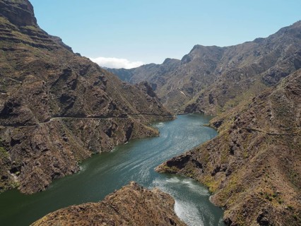 Mountain valley with a large reservoir under a clear sky, Presa del Parralillo, Gran Canaria, Spain