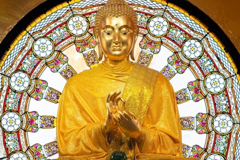 In the main chedi of Wat Phra That Sorn Kaew, the gilded Buddha statue shines out against a