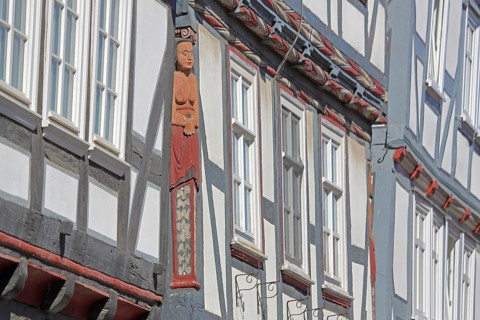 Half-timbered house with wood carvings, ornaments, relief, handicraft, female figure, row of