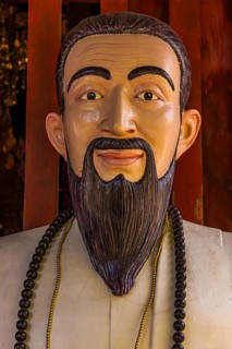 Colored wooden sculpture of Confucius, Wat Phra Singh Buddhist temple complex, Chiang Mai Old City