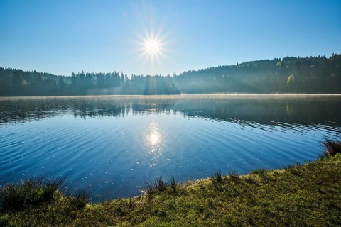Morning view of a lake with beautiful sun reflection in water, Windgfällweiher, Lenzkirch, Black