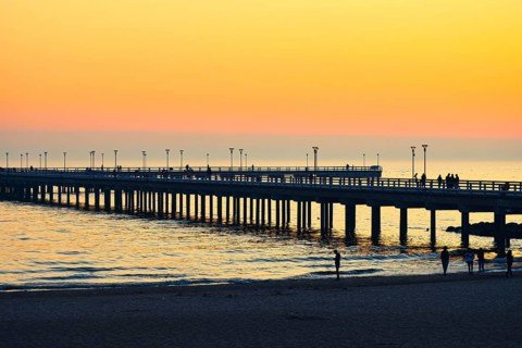 Dramatic colorful sunset at famous marine pier in Baltic resort city of Palanga. Lithuania