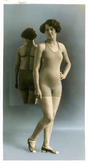 Swimwear, England, woman in swimsuit standing with reflection in the background in a studio,