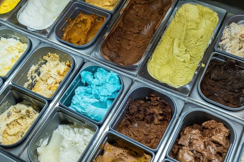 Variety of classic and unique ice cream flavors and gelato in a refrigerated display case, offering
