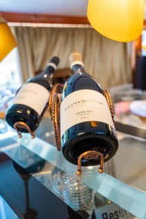 Two wine bottles in elegant holders in a stylish and well-lit restaurant, Schifffahrt, Neckar,