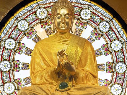 In the main chedi of Wat Phra That Sorn Kaew, the gilded Buddha statue shines out against a