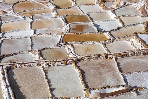 Individual terraces of the Salinas de Maras, salt terraces on a mountainside for salt production