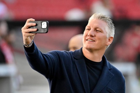 TV expert Bastian Schweinsteiger takes selfie with smartphone, mobile phone, smiles, soccer