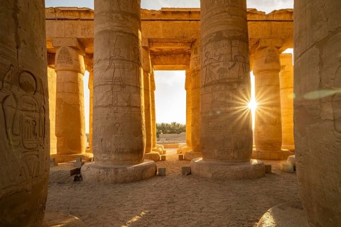 The sun between the pillars of Ramesseum, mortuary temple of Ramesses II in the Theban necropolis